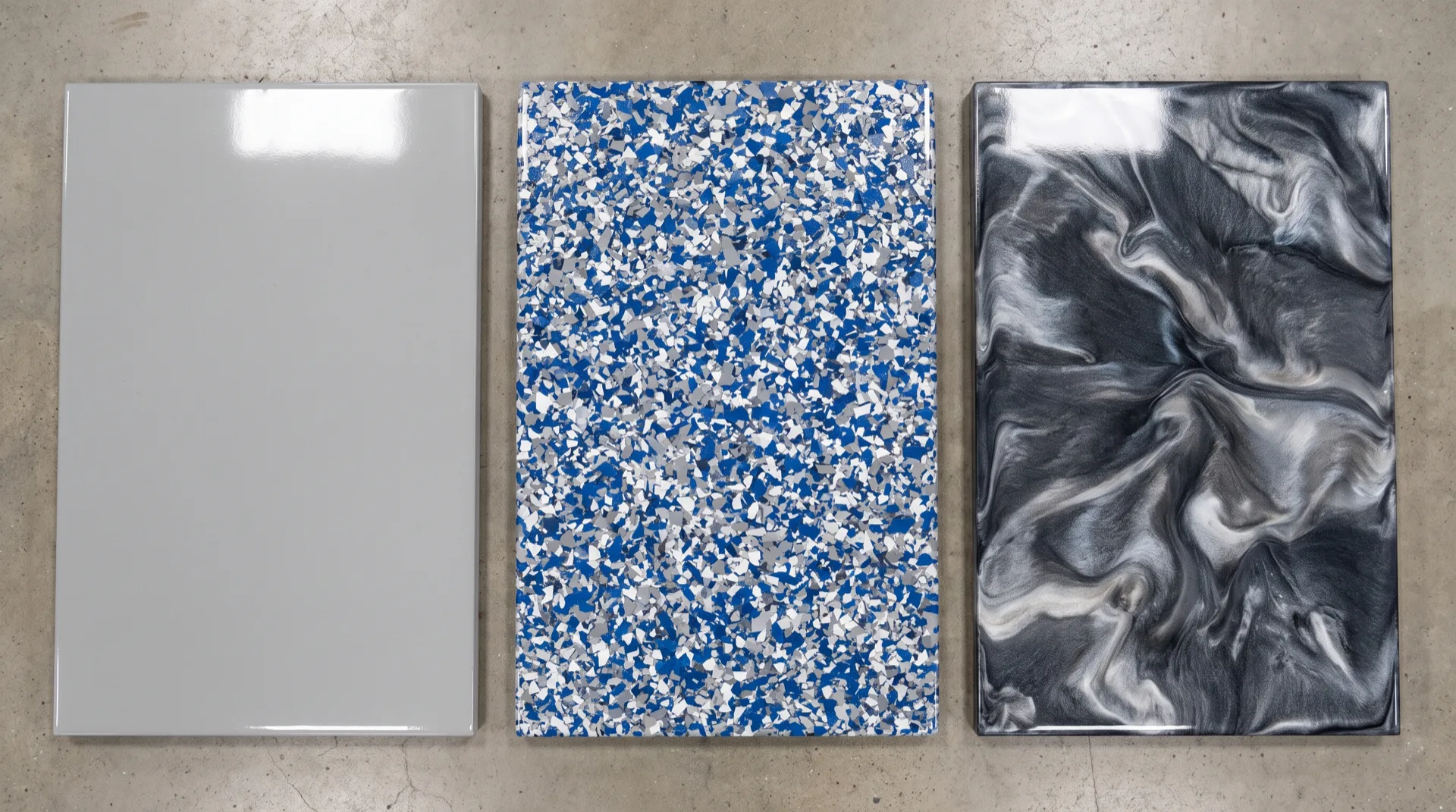 Solid color, flake, and metallic epoxy garage floor sample panels compared side by side for a San Antonio project