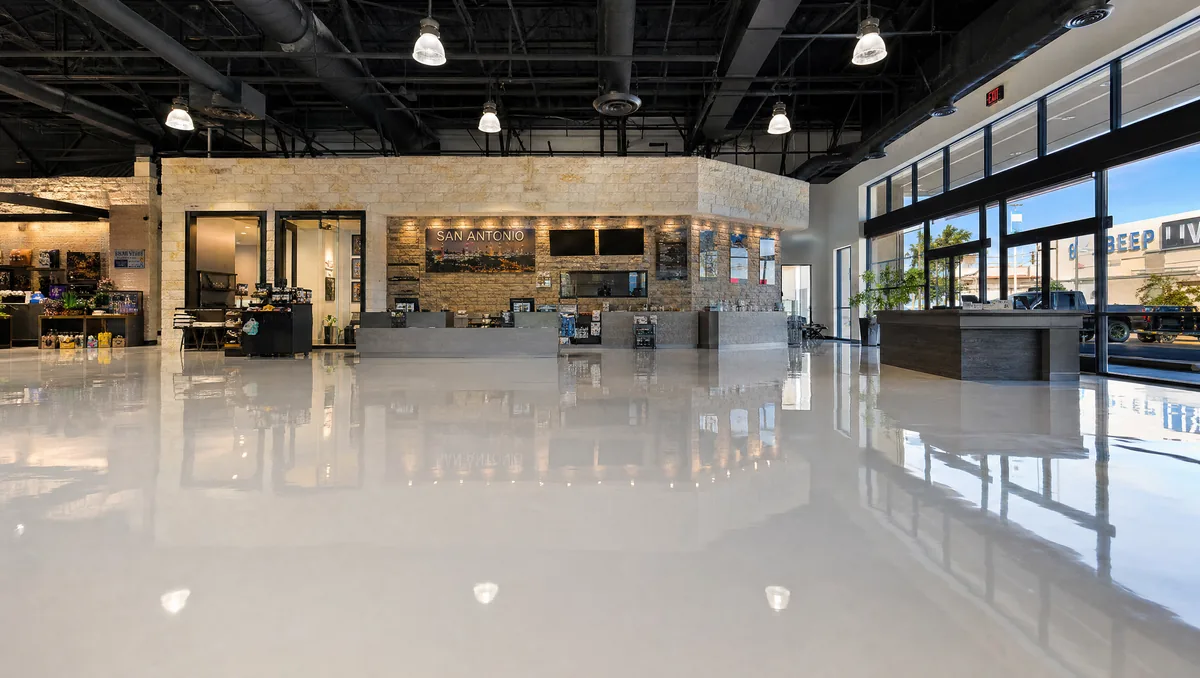 Large commercial warehouse in San Antonio with freshly installed high-build epoxy floor coating, grey seamless finish