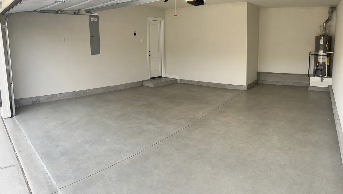 New construction garage slab in San Antonio neighborhood with fresh concrete ready for epoxy coating after proper cure period